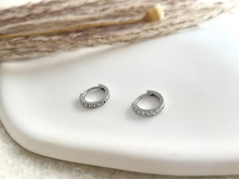 Delicate Silver Huggie Hoops featuring an everyday sterling silver earring stack set designed for multiple piercings – the perfect gift idea for her